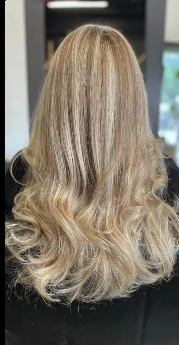 Bright blonde balayage with curled style